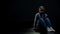 Sad little girl sitting alone in dark room, loneliness and bullying concept