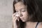 Sad and lonely girl beside wall