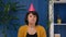 Sad lonely Middle aged woman in party hat celebrating birthday alone, depression, crisis.