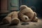 Sad lonely teddy bear lying on the floor symbol of abuse victims