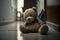Sad lonely teddy bear lying on the floor symbol of abuse victims