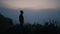 Sad man silhouette standing on mountain top. Lonely guy looking autumn landscape