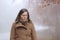 Sad middle age woman looking down in a forest in autumn