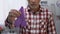 Sad old man holding purple ribbon, cancer and Alzheimers disease awareness