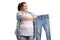 Sad overweight woman holding a pair of small jeans