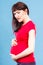 Sad pregnant woman with stomach pain touching her belly, aches in pregnancy and risk of miscarriage