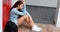 Sad schoolgirl sitting alone near locker