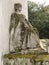 Sad sitted sculpture of a woman looking at the horizon in a tomb in the Pere Lachaise cemetery. All Saints Day, November 1, Day of