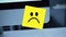 Sad smile. Sad face painted on a sticker on the monitor