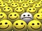 Sad smiley in a crowd of happy smileys