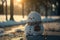 Sad snowman melts in park with arrival of spring. Snowman in the rays of warm spring sun. Grass under snow. 3d illustration