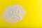 Sad sugar face on the yellow background. Bad food.