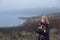 Sad  teenager  girl hugging  teddy bear by foggy  lake.  Concept of adolescence and adolescent problems