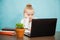 Sad tired elementary student girl homeschooling on laptop online