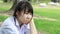 Sad Unhappy thai student teen Sitting On Park