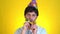 Sad upset serious man in birthday hat basic in pipe celebrate party day isolated on yellow background studio. People