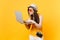 Sad upset tourist woman in summer casual clothes, hat holding laptop pc computer isolated on yellow orange background