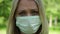 Sad, upset young woman in a medical mask. Sad girl in a protective mask
