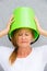 Sad woman with bucket on head