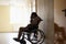 Sad woman disabled sitting in wheelchair and holding her head in clinic