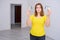 Sad woman in an empty apartment holding torn money. The concept of wasted Finance, credit and problems with dollars