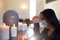 Sad woman in mask praying at funeral in church