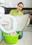 Sad woman near washing machine