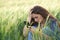 Sad woman reading phone chat in a field