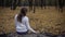 Sad woman sitting in autumn park remembering deceased husband, loss of loved one