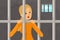 Sad woman standing in prison. Person in orange clothing