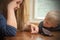 A sad woman at the table thinks the last coins. Empty wallet - boy son calms mother.