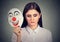 Sad woman taking off clown mask expressing happiness