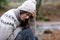 Sad woman in winter complaining alone in a forest