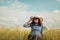 Sad young girl sitting alone on a grass outdoors,Sadness. Loneliness