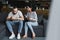 sad young man sitting on sofa and looking away while his wife shouting at him and holding