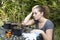 Sad young woman looking at dry flowers