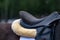 Saddle on horse in equestrian competitions. close-up, foot in the stirrup. dressage or outdoor training