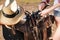 Saddle prepared for horse riding by young woman cowgirl