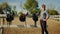 Saddles Hanging On The Wooden Fence In The Sandy Arena - Girl Looking back