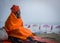 A SADHU IN MELANCHOLIC MOOD AT ASSI GHAT, VARANASI