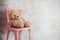 Sadness and Loneliness Concept. Lonely Teddy Bear Toy Siting Alone on Chair in House