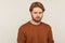 Sadness and resentment emotions. Portrait of unhappy bearded man in sweatshirt. isolated on gray background
