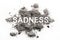 Sadness word written in ash