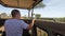 Safari_24A tourist in a white T-shirt stands in a large safari jeep and watches the zebras. The amazing nature of Africa.