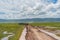 Safari dirty offroad jeeps driving on busy dirt road in Tanzania