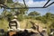 Safari drive in open vehicle in South Africa. Ranger looking for animals