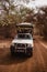 Safari Jeep with tourists going away forward on sandy road. Wild life in Safari. Baobab and bush jungles in Senegal, Africa.