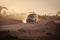 Safari Land Cruiser vehicle drives on the dusty roads at sunset