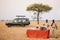 Safari outdoor picnic with beverage bar in Savanna field of Serengeti forest