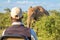 A safari tracker watching an elephant in front of the car, Madikwe Game Reserve, South Africa.